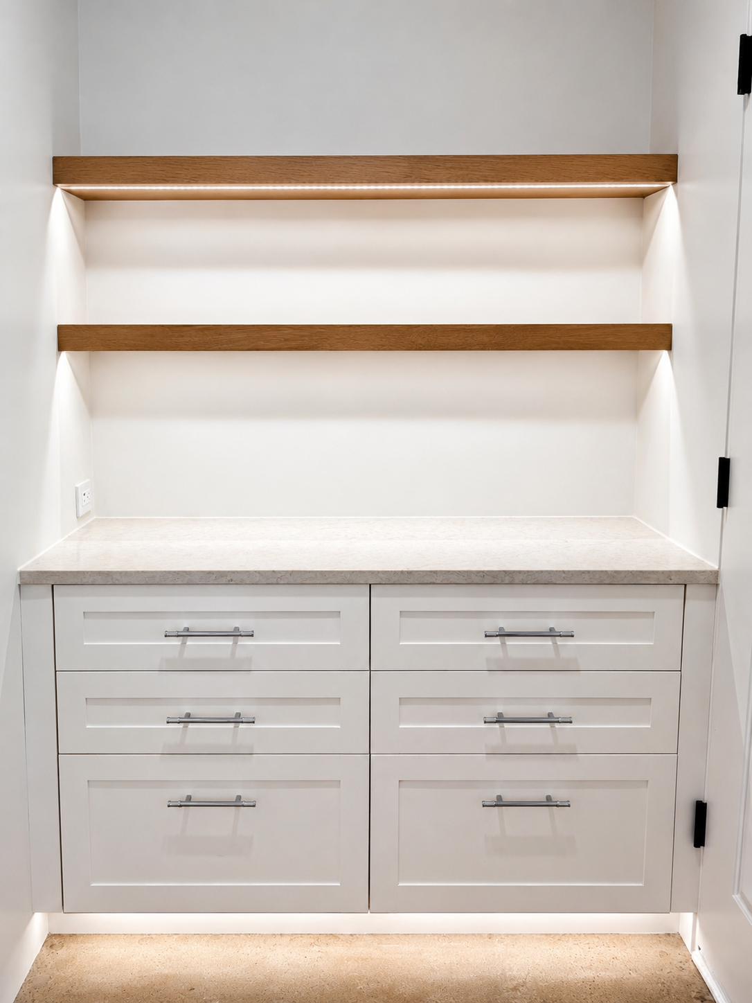 Custom built-in cabinetry with floating white oak shelves and integrated LED lighting