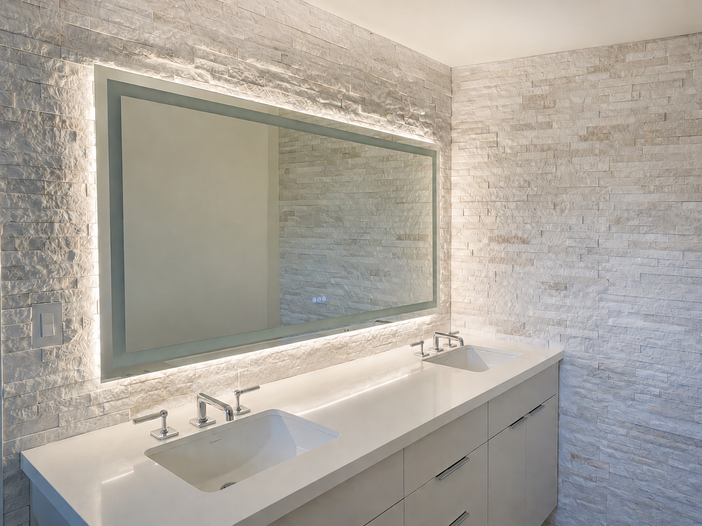 Spa-inspired bathroom remodel with stone feature wall and dual vanity with backlit led mirror and luxury hardware